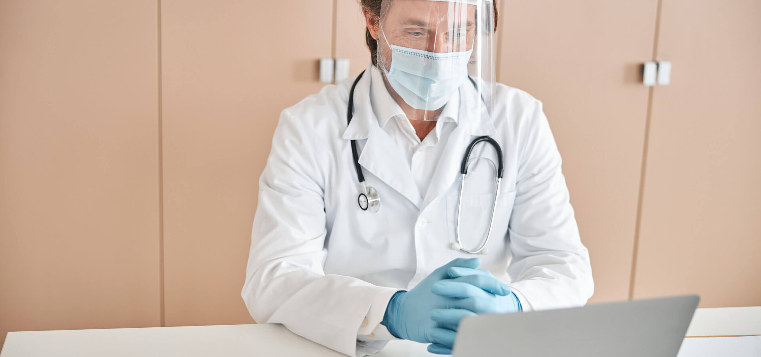 Certyfikaty P1 - powiadomienia e-mail - lekarz pracujący na laptopie w gabinecie